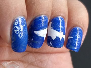 La-sea with a Chance of Sharks - Hermit Werds - nail art with elegant blue lace ocean with a great white shark stamped on top