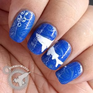 La-sea with a Chance of Sharks - Hermit Werds - nail art with elegant blue lace ocean with a great white shark stamped on top