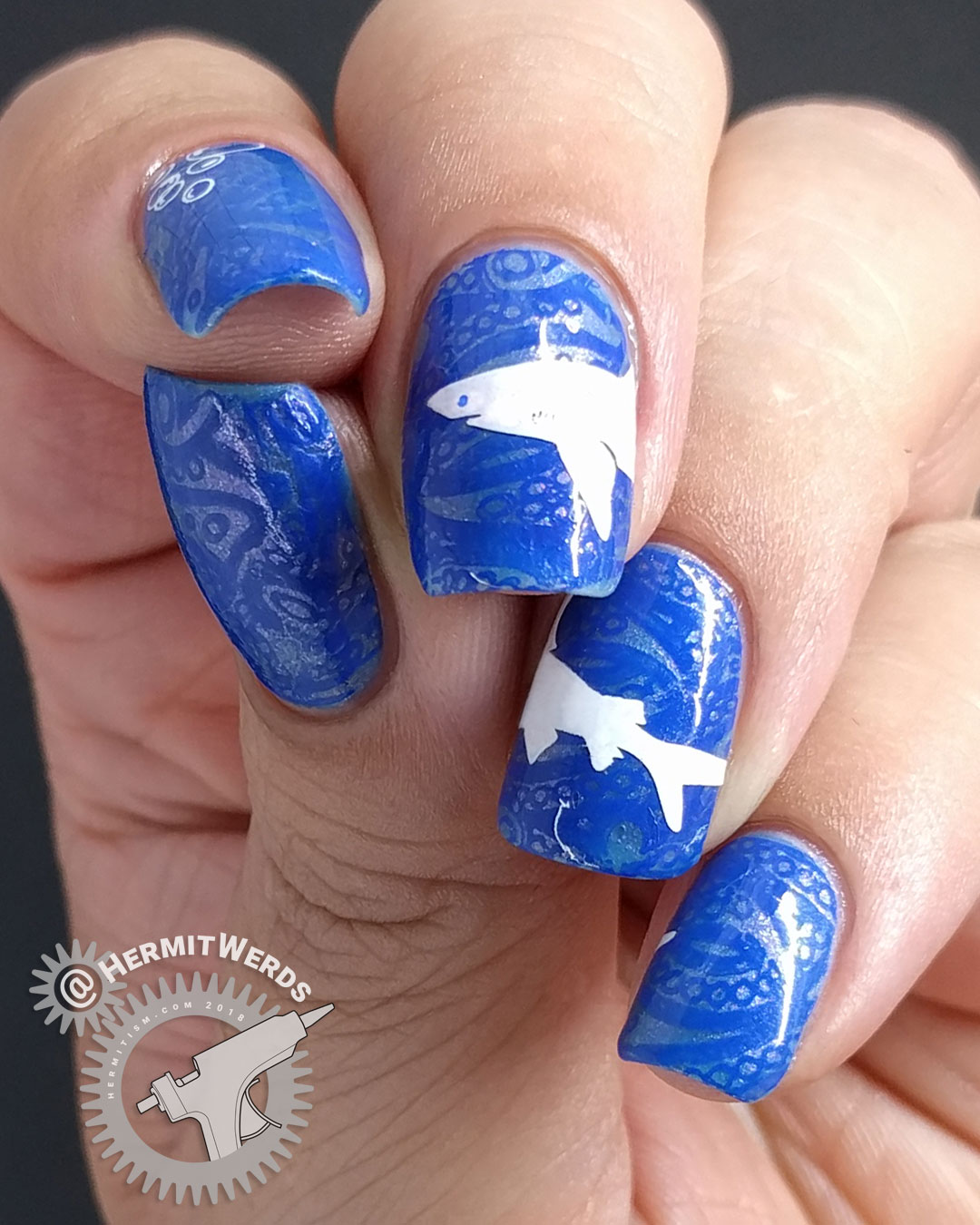La-sea with a Chance of Sharks - Hermit Werds - nail art with elegant blue lace ocean with a great white shark stamped on top