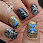 Paisley Whale - Hermit Werds - nail art with a dark blue and cream paisley pattern and two glittery gold whale accent nails