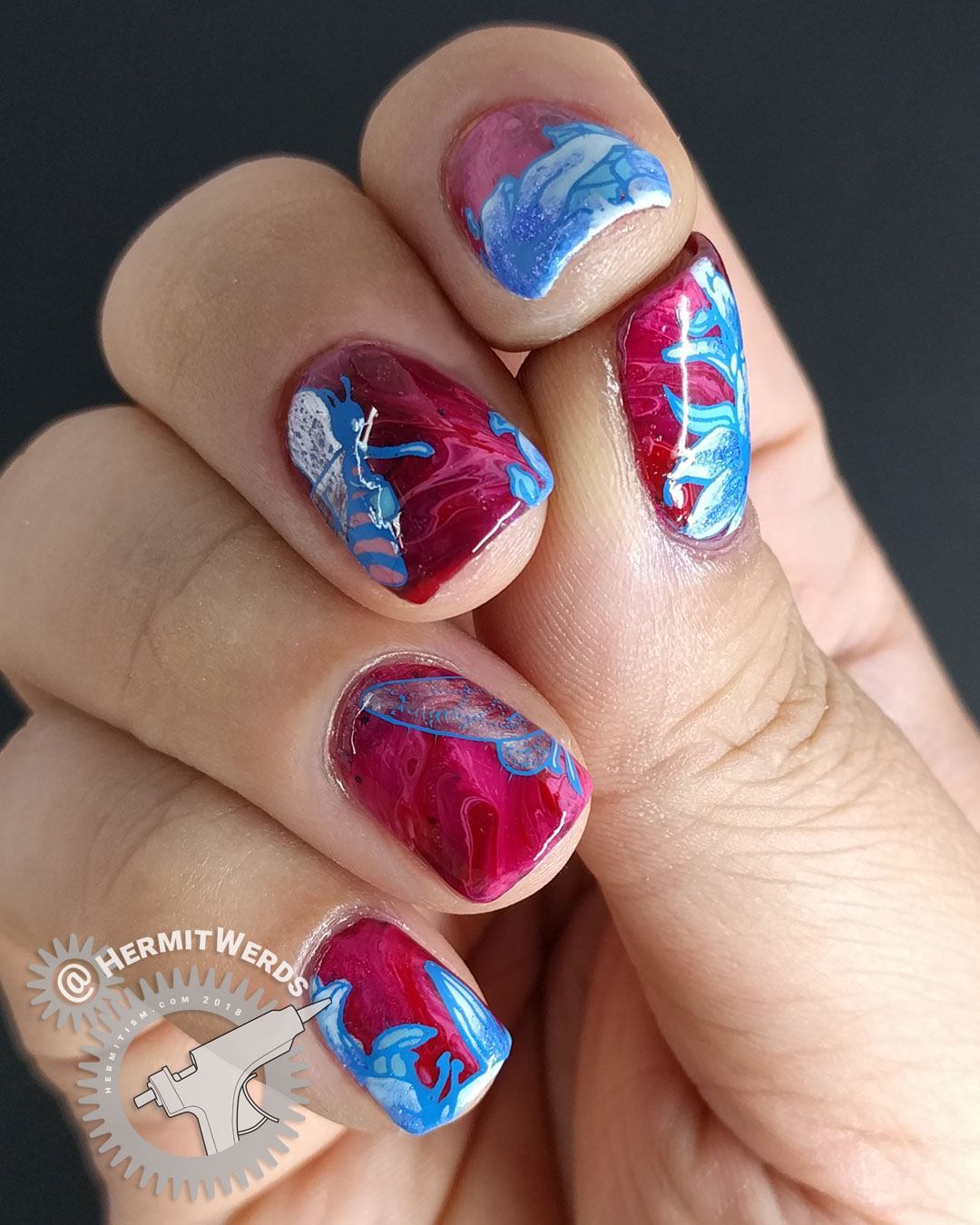 Lady of the Bees 2.0 - Hermit Werds - blue bee fairy stamping decal and lilies on a red to pink fluid art base.