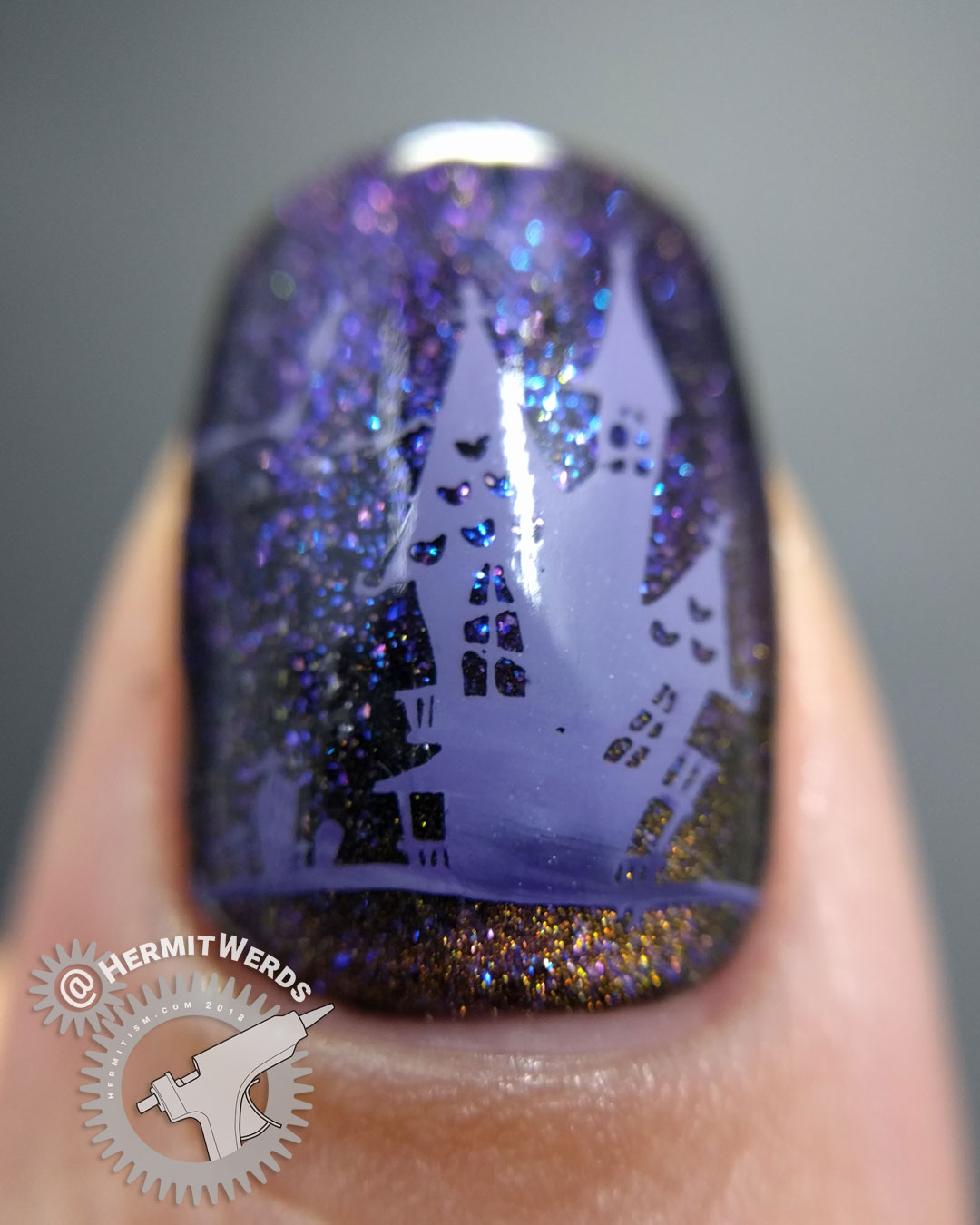 Thankfully Halloween - Hermit Werds - purple magnetic polish with spooky stamping (spider, ghouls, bats, haunted house) on top