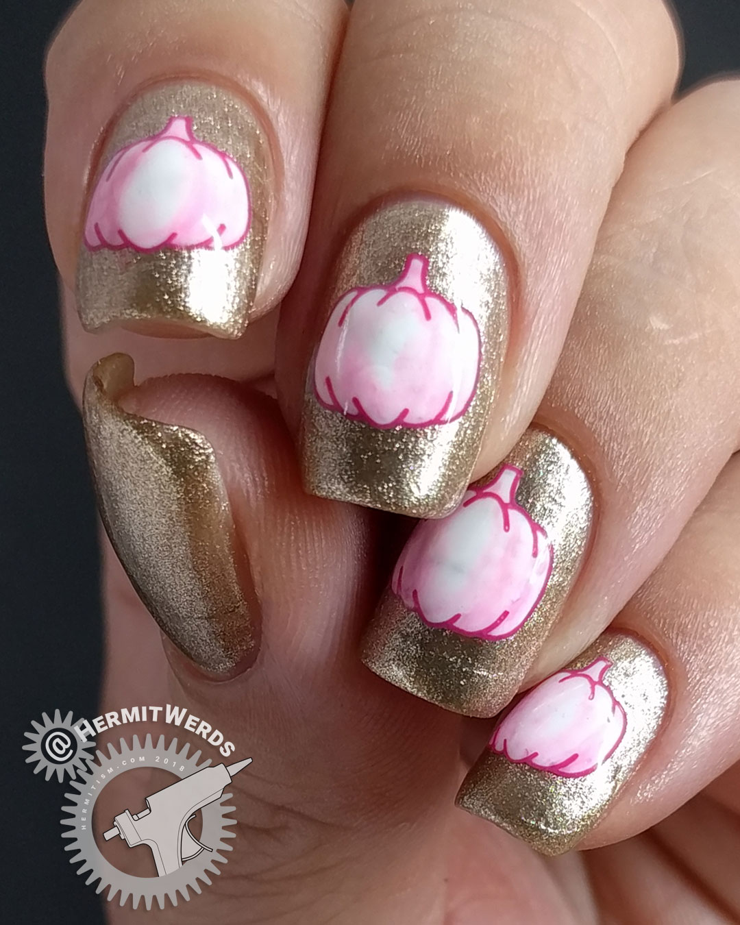Glam-kin - Hermit Werds - nail art of a white pumpkin stamping tinted a little bit pink on a glitzy golden background