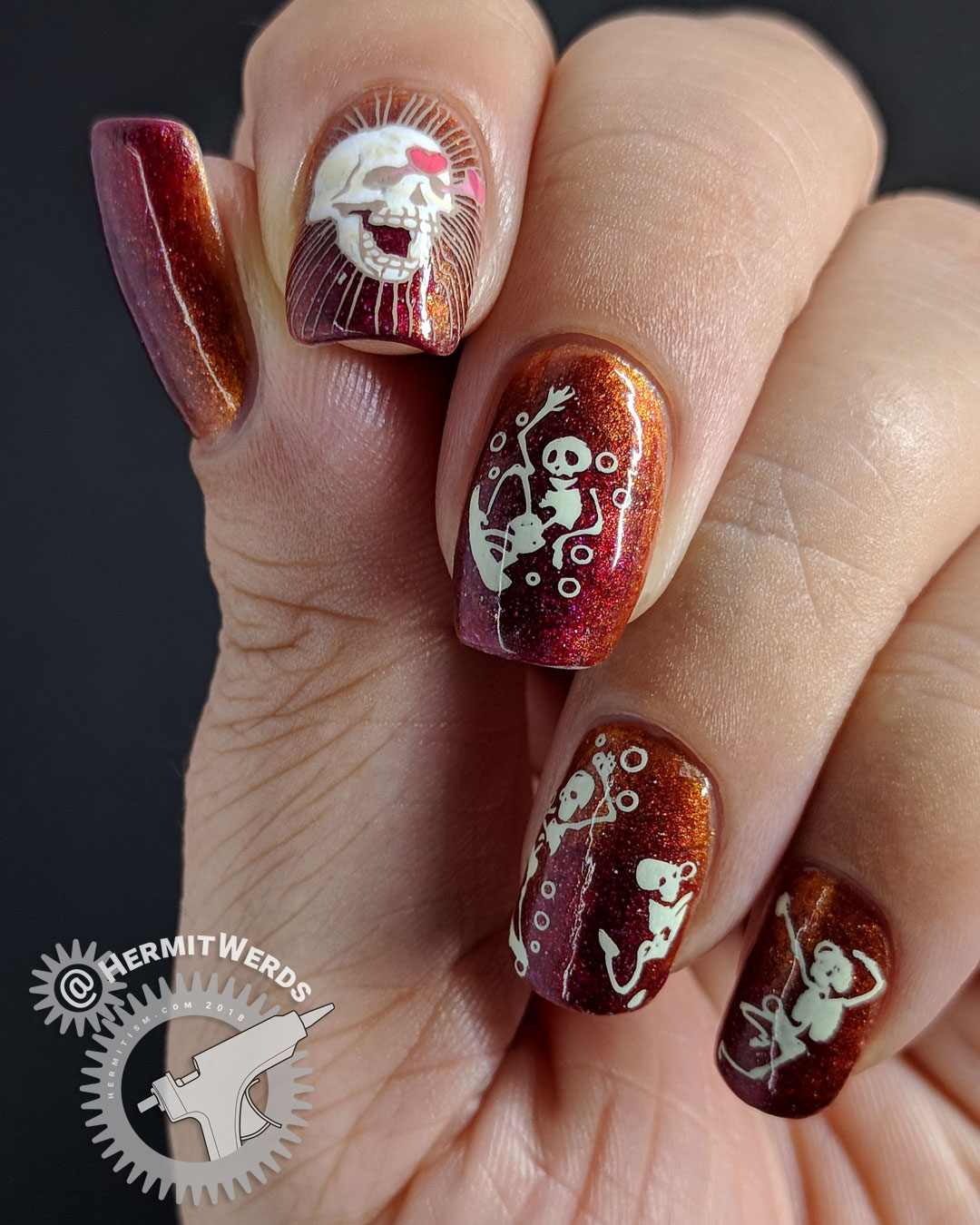 Hunka Hunka Skeleton - Hermit Werds - nail art featuring hunky skeletons showing off for interested skull stamped over a copper and red gradient