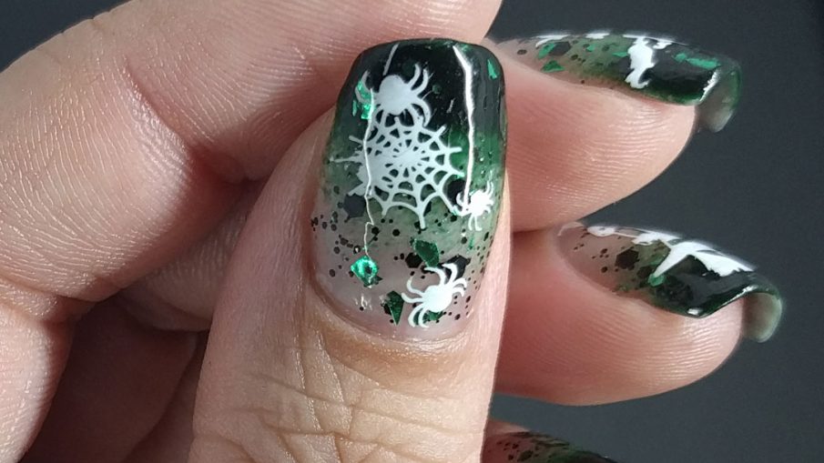 Witch of Spiders - Hermit Werds- dark green baby boomer french tips with black and green glitter and white witch and spider stamping on top