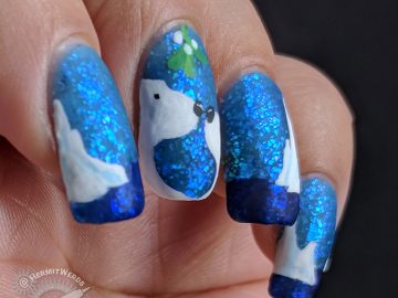Sinful Colors' "Bangin' Blue" - Hermit Werds - freehand nail art of two polar bears about to kiss beneath the mistletoe on a blue jelly polish full of iridescent glitter with icebergs decorating the other nails