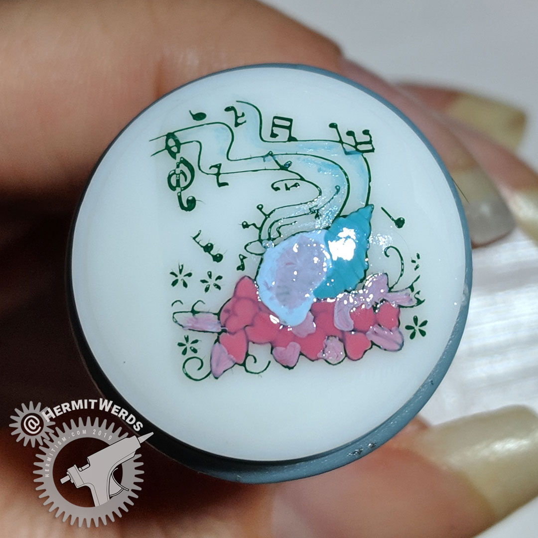 Glitter Conch - stamping decal - Hermit Werds - a reverse/advanced stamping decal on a conch shell still on the stamper