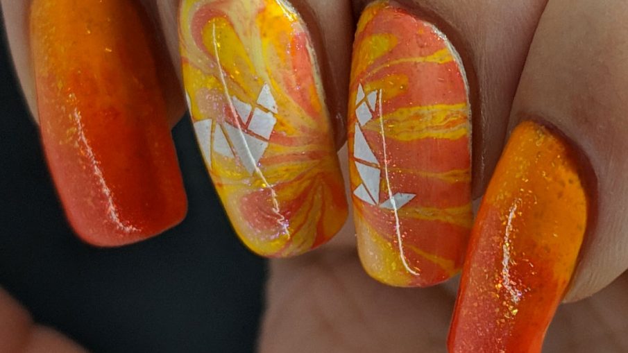 Kitty Tangrams - Hermit Werds - sparkly orange water marble nail art with two white cat tangram puzzles stamped on top
