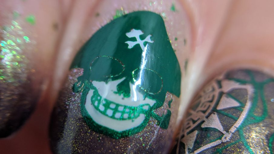 Brown and green skeletal pirate nail art with map and compass.