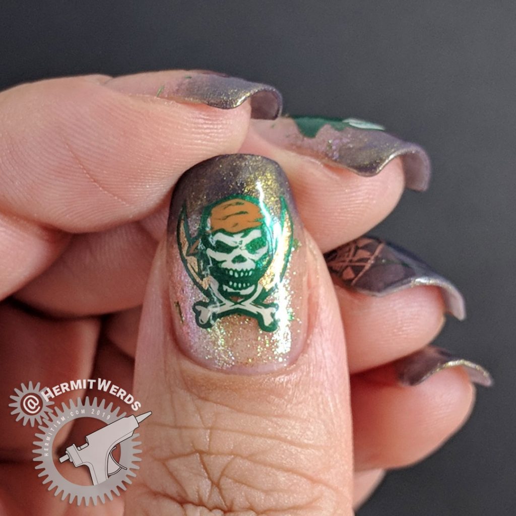 Brown and green skeletal pirate nail art with map and compass.