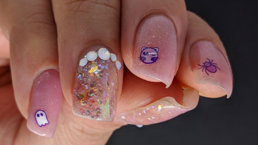 Delicate pink nail art with cute Halloween icons and opal glitters and rhinestones.