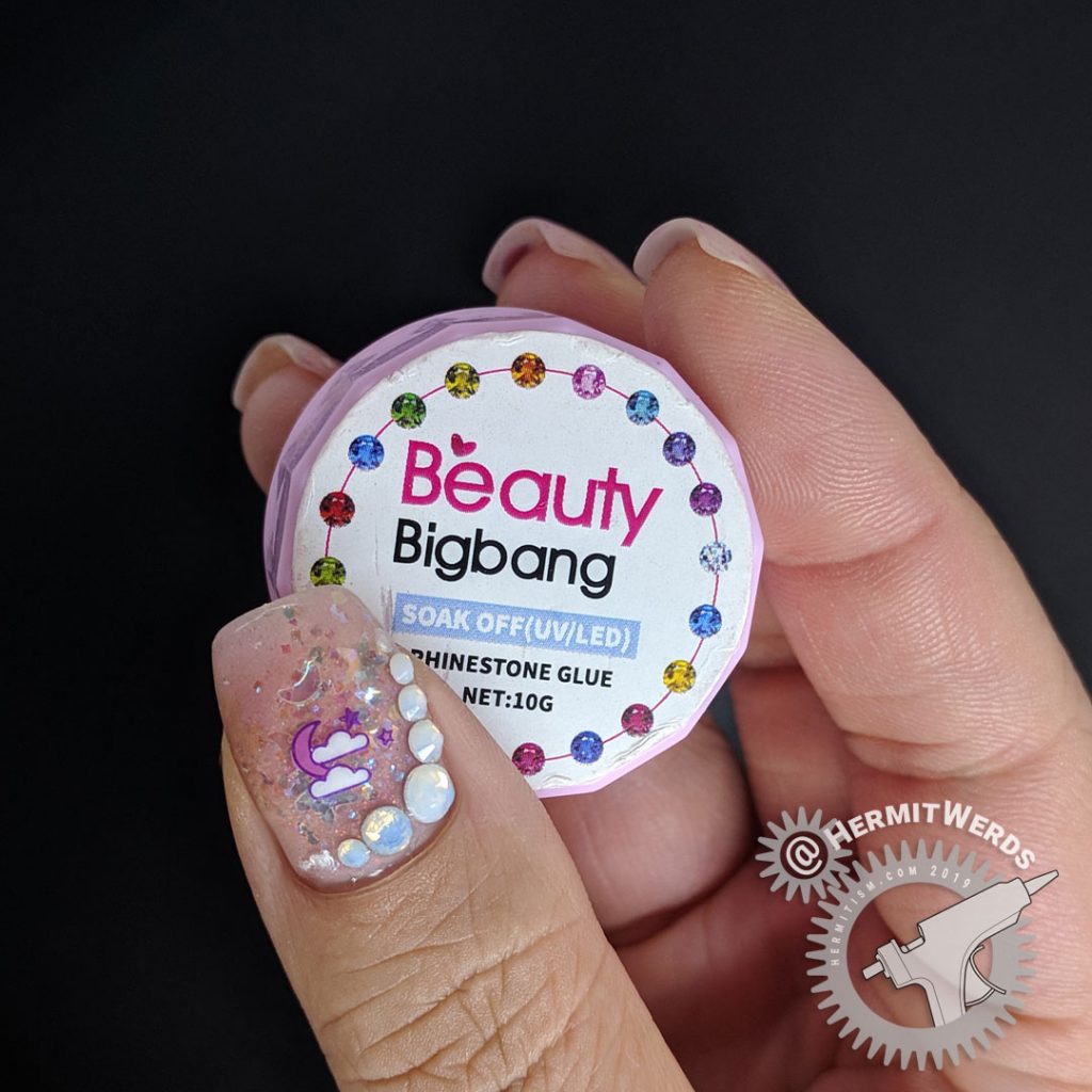 Delicate pink nail art with cute Halloween icons and opal glitters and rhinestones.