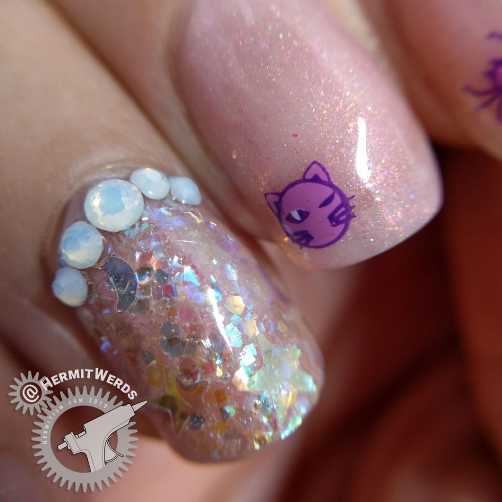 Delicate pink nail art with cute Halloween icons and opal glitters and rhinestones.