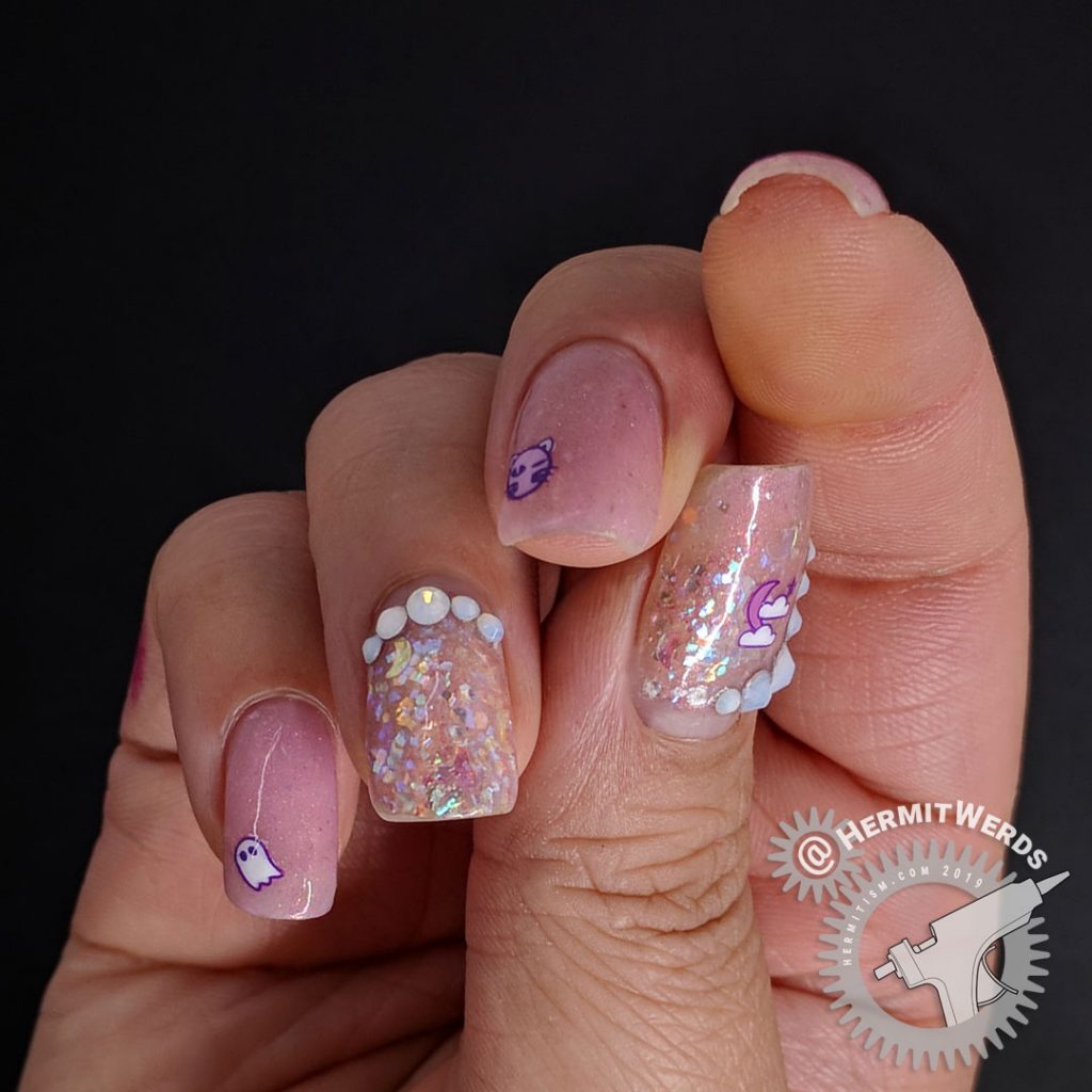 Delicate pink nail art with cute Halloween icons and opal glitters and rhinestones.