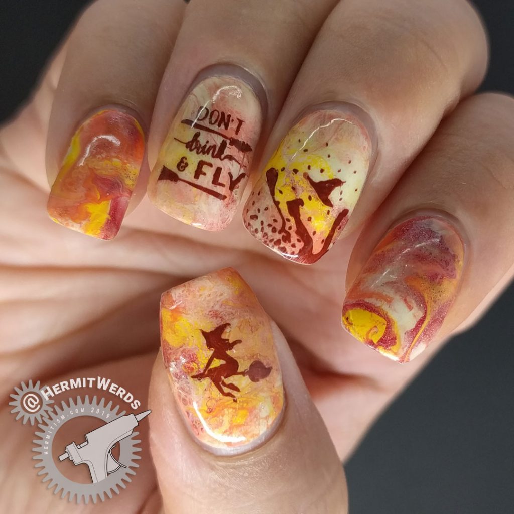 Orange, yellow, and coral fluid art nails with witch nail art stamped on top. Don't drink and fly!