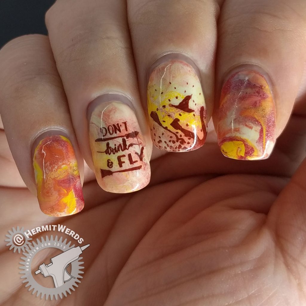 Orange, yellow, and coral fluid art nails with witch nail art stamped on top. Don't drink and fly!