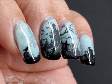 Glow in the dark haunted graveyard nail art with overlooking castle.