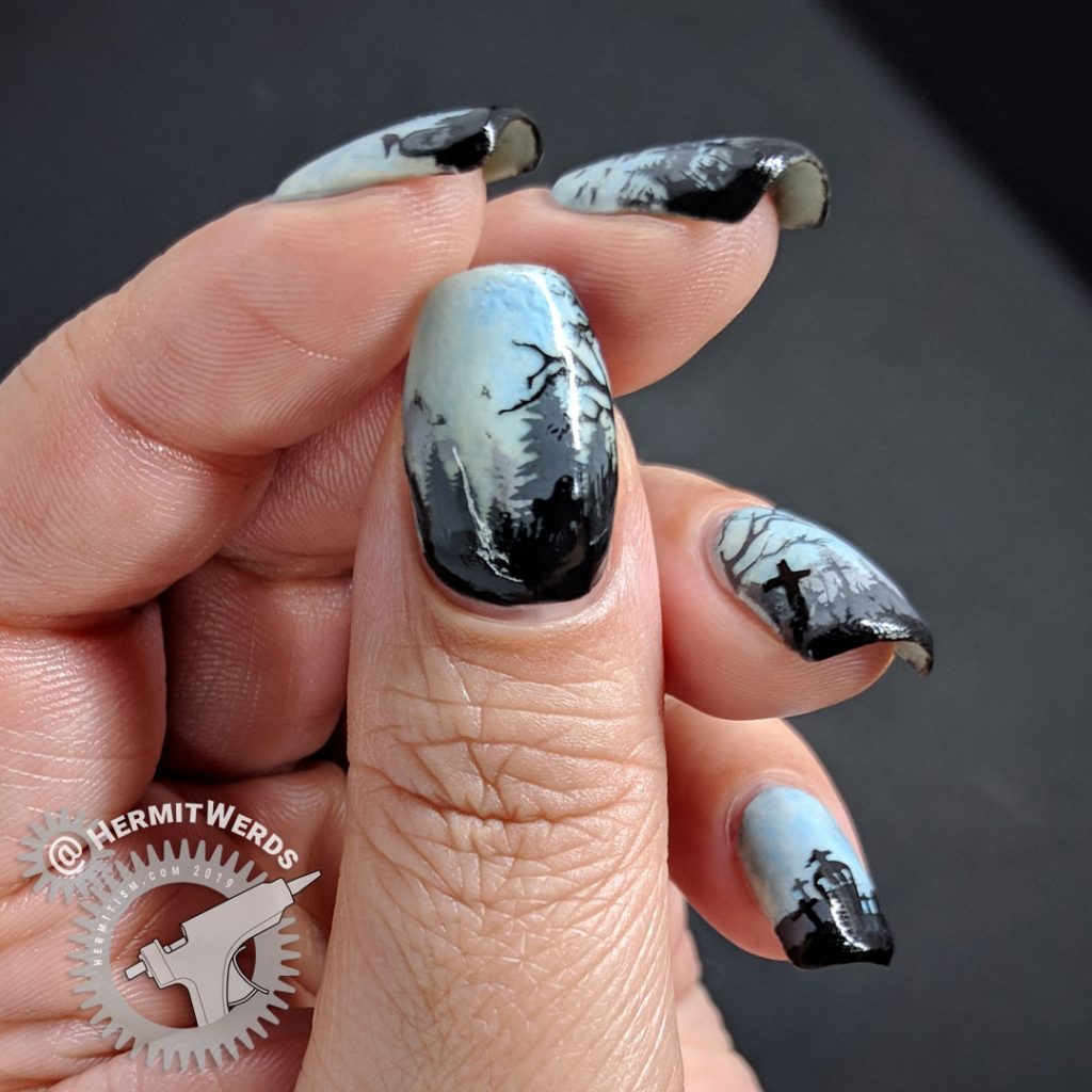 Glow in the dark haunted graveyard nail art with overlooking castle.