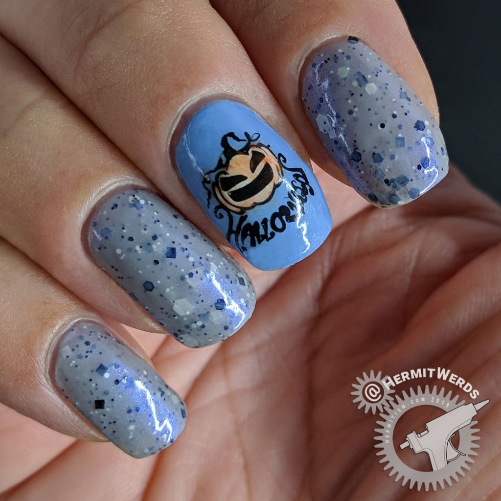 Grey crelly polish with blue jack-o-lantern nails colored in with watercolor paint.