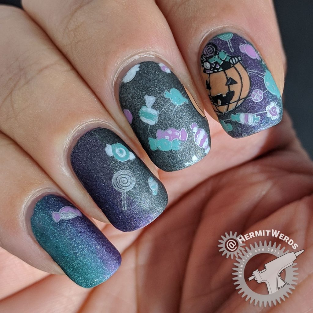 Black, purple, and teal holographic galaxy nail art with Halloween jack-o-lantern planet and space candy.