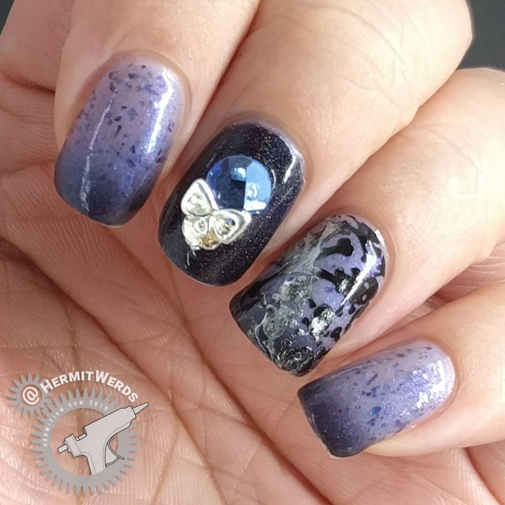 Blurple thermal nail art with skulls and skeletons and a blue and silver rhinestone.