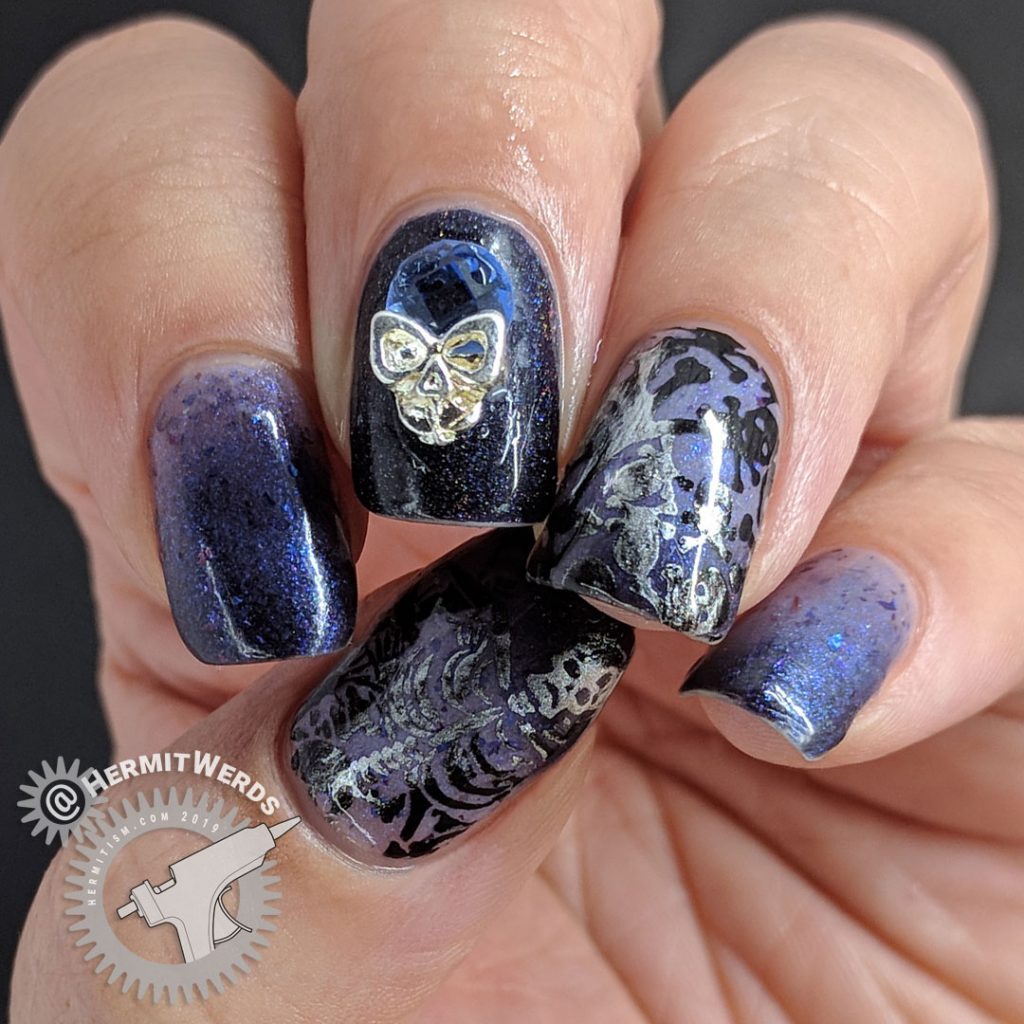 Blurple thermal nail art with skulls and skeletons and a blue and silver rhinestone.