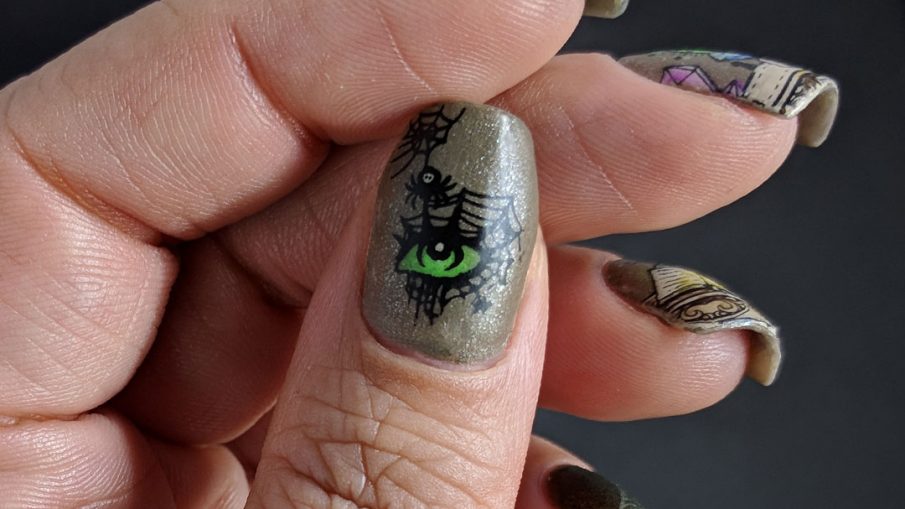 Neutral colored nail art of an evil magic spell to summon a spider queen. Lots of spider webs.