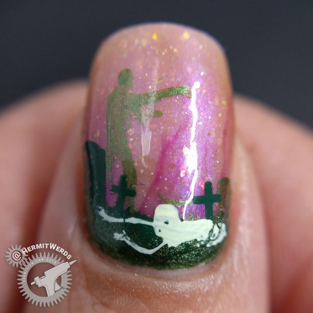 A delicately gruesome zombie nail art using a translucent shimmery orange polish and soft metallic green zombies.