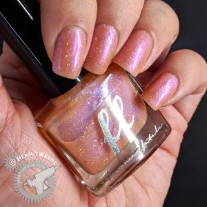 Femme Fatale polish swatch of a translucent, soft, warm ochre orange offset with a violet purple shine, green-blue shifting flakes, lime holographic glitters, coral-gold iridescent glitters, red-green shifting iridescent glitters and fine holographic particles.