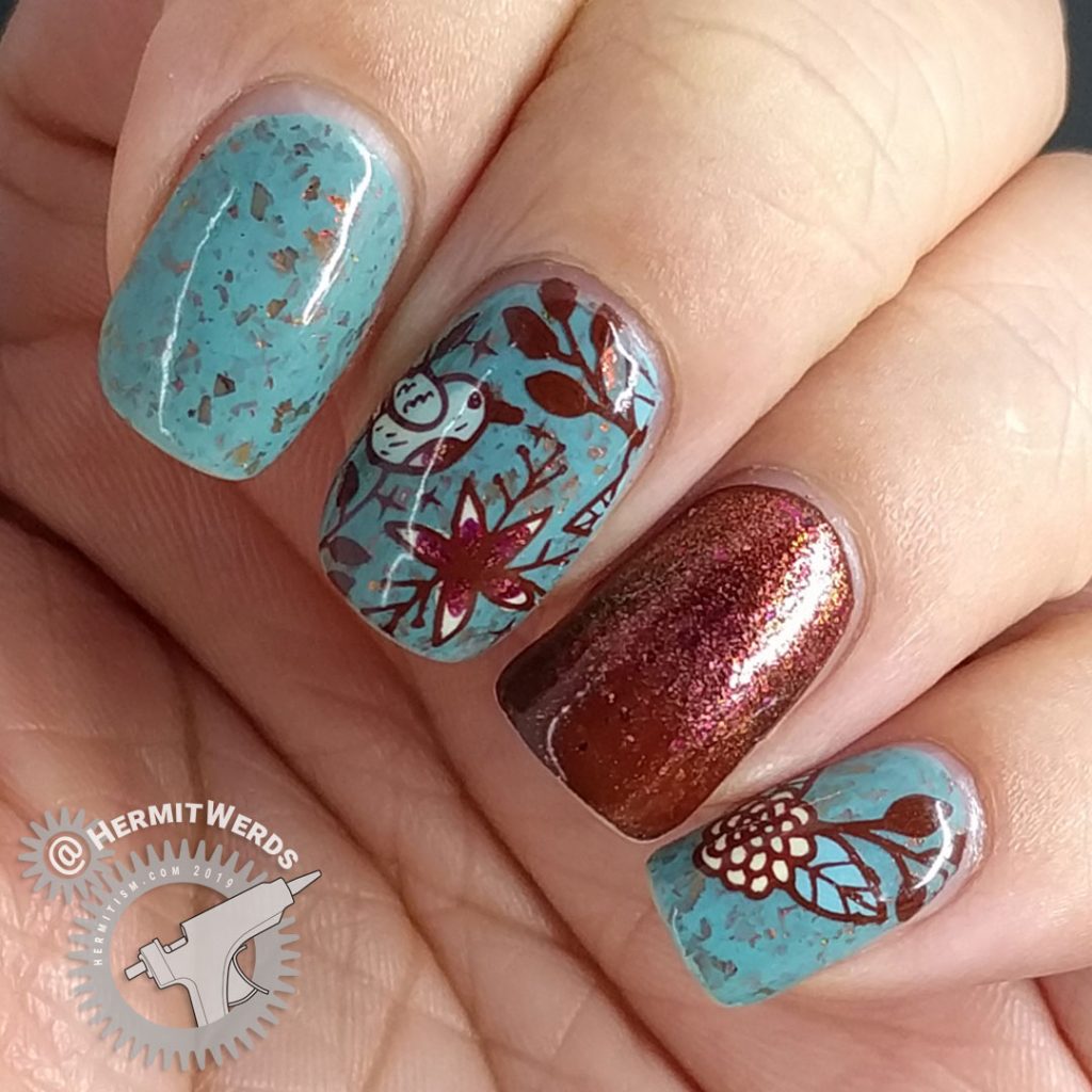 Autumnal nail art with a little blue bird against a robin blue crelly full of pink/orange/red flakies.