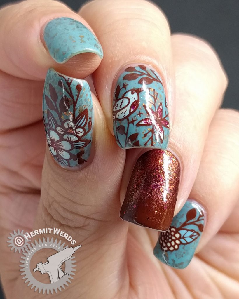 Autumnal nail art with a little blue bird against a robin blue crelly full of pink/orange/red flakies.