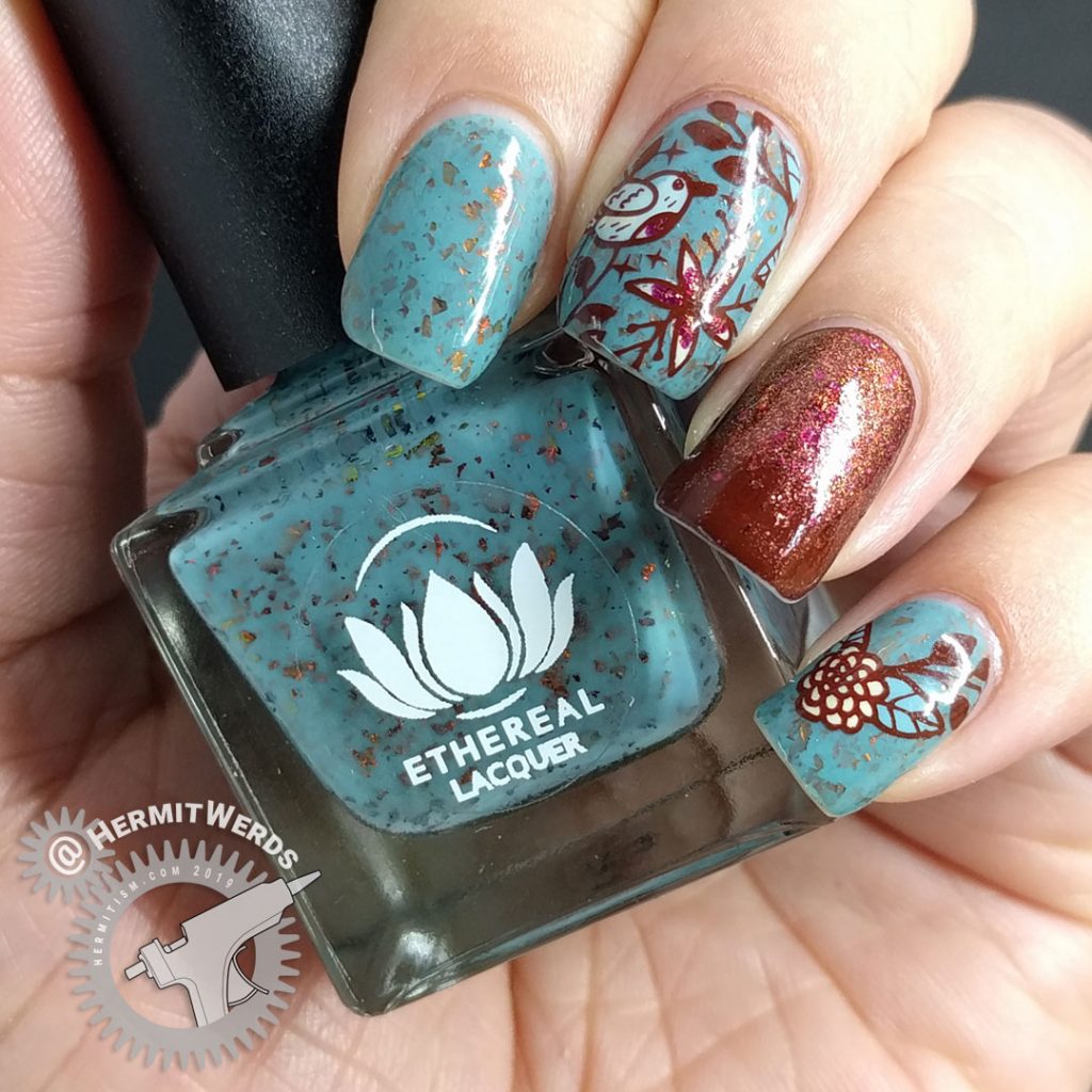 Autumnal nail art with a little blue bird against a robin blue crelly full of pink/orange/red flakies.