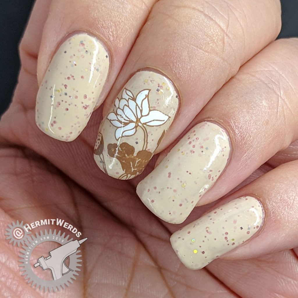 A soft crelly nail art in neutral shades with floral lily pad stamping.