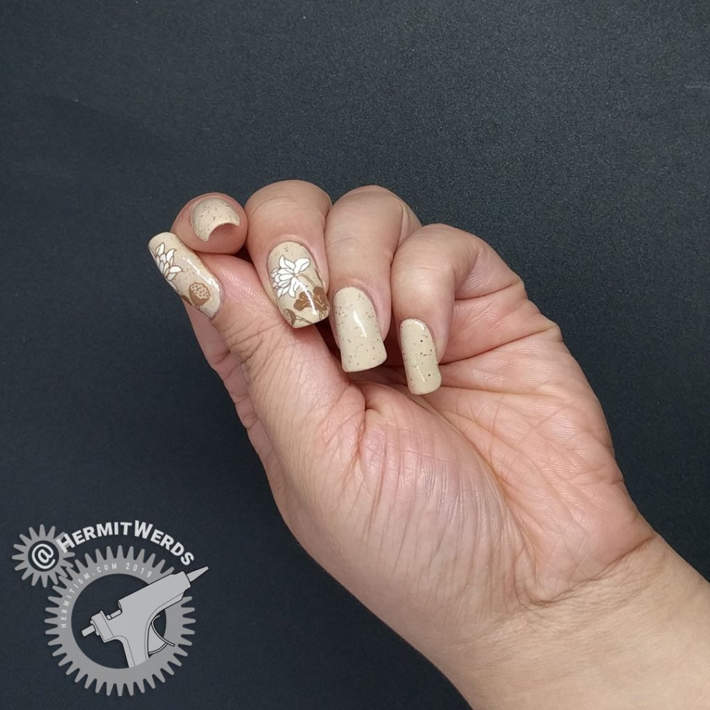 A soft crelly nail art in neutral shades with floral lily pad stamping.