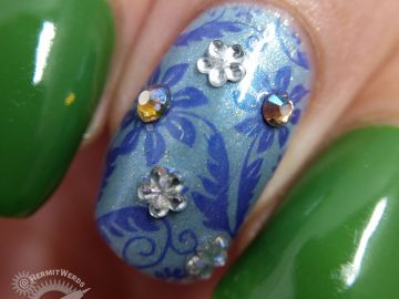 Floral nail art featuring Pantone's Eden and blue floral accent nails with rhinestones.