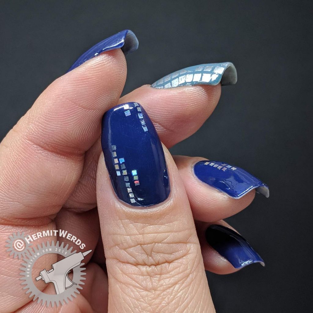 Blue nail art with holographic silver squares and a glamourous lady shopper