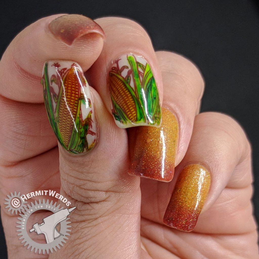 Mustard and terracotta thermal polish with corn decals colored in with Sharpie markers.