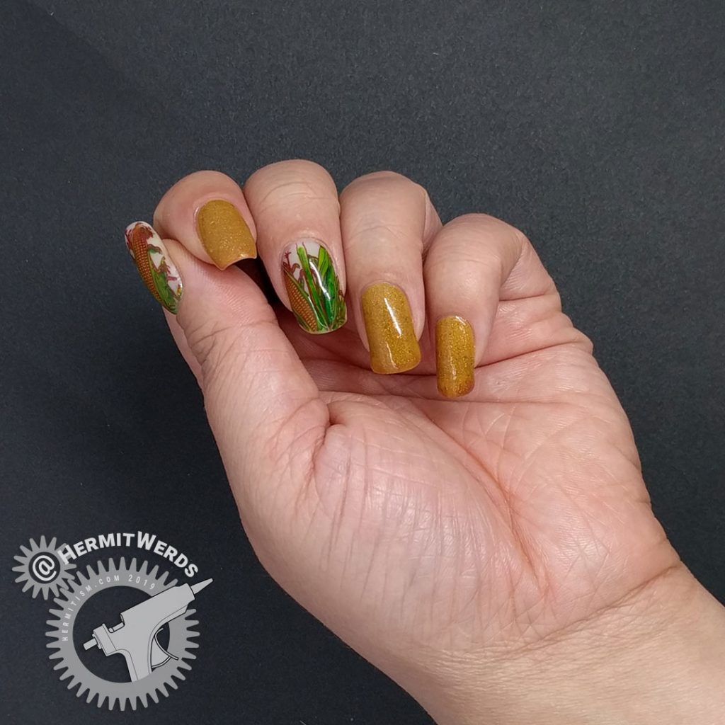 Mustard and terracotta thermal polish with corn decals colored in with Sharpie markers.