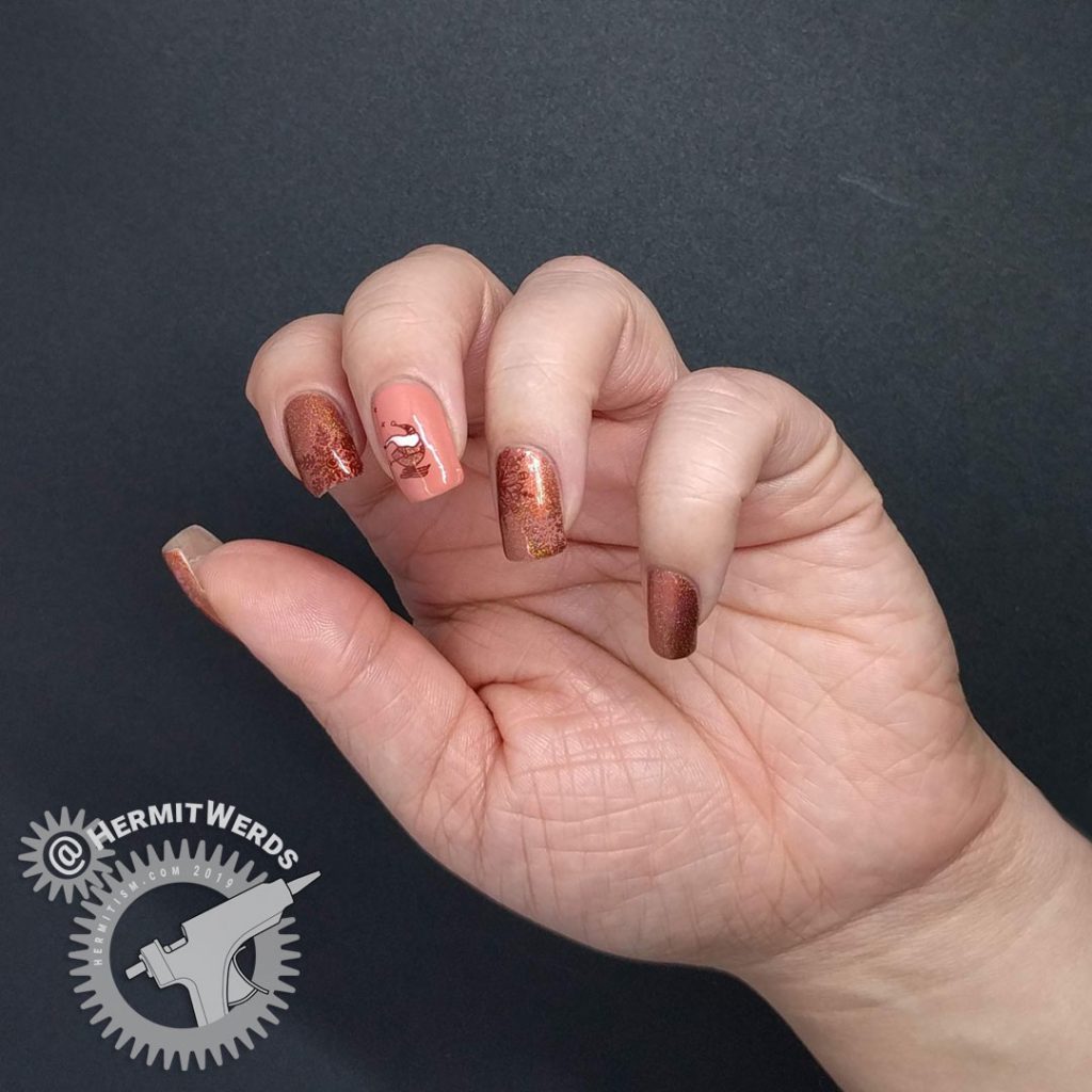 Adorable skiing Santa nail art with an orange holographic color scheme and snow flake stamps.