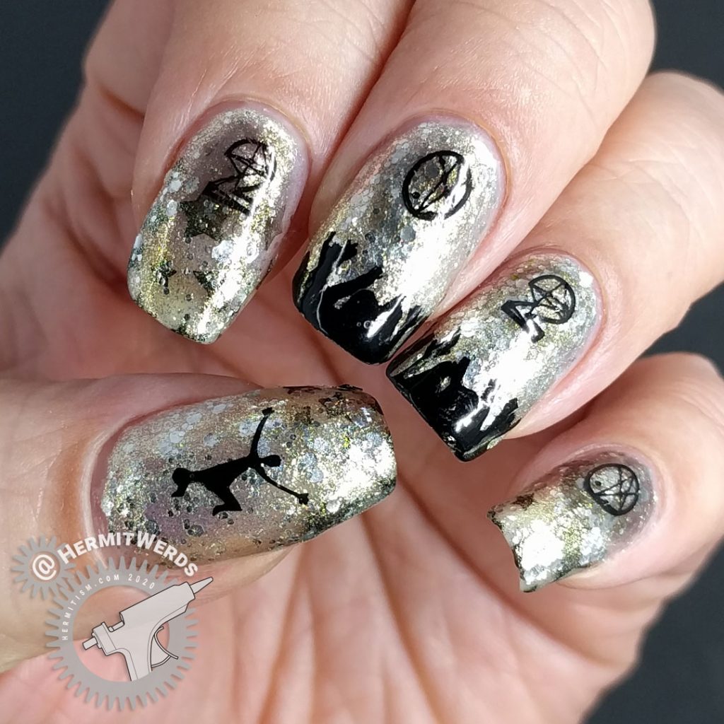 Glittery silver and gold nail art with people cheering and partying underneath a 2020 stamping image.