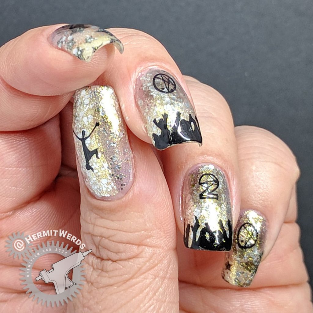 Glittery silver and gold nail art with people cheering and partying underneath a 2020 stamping image.