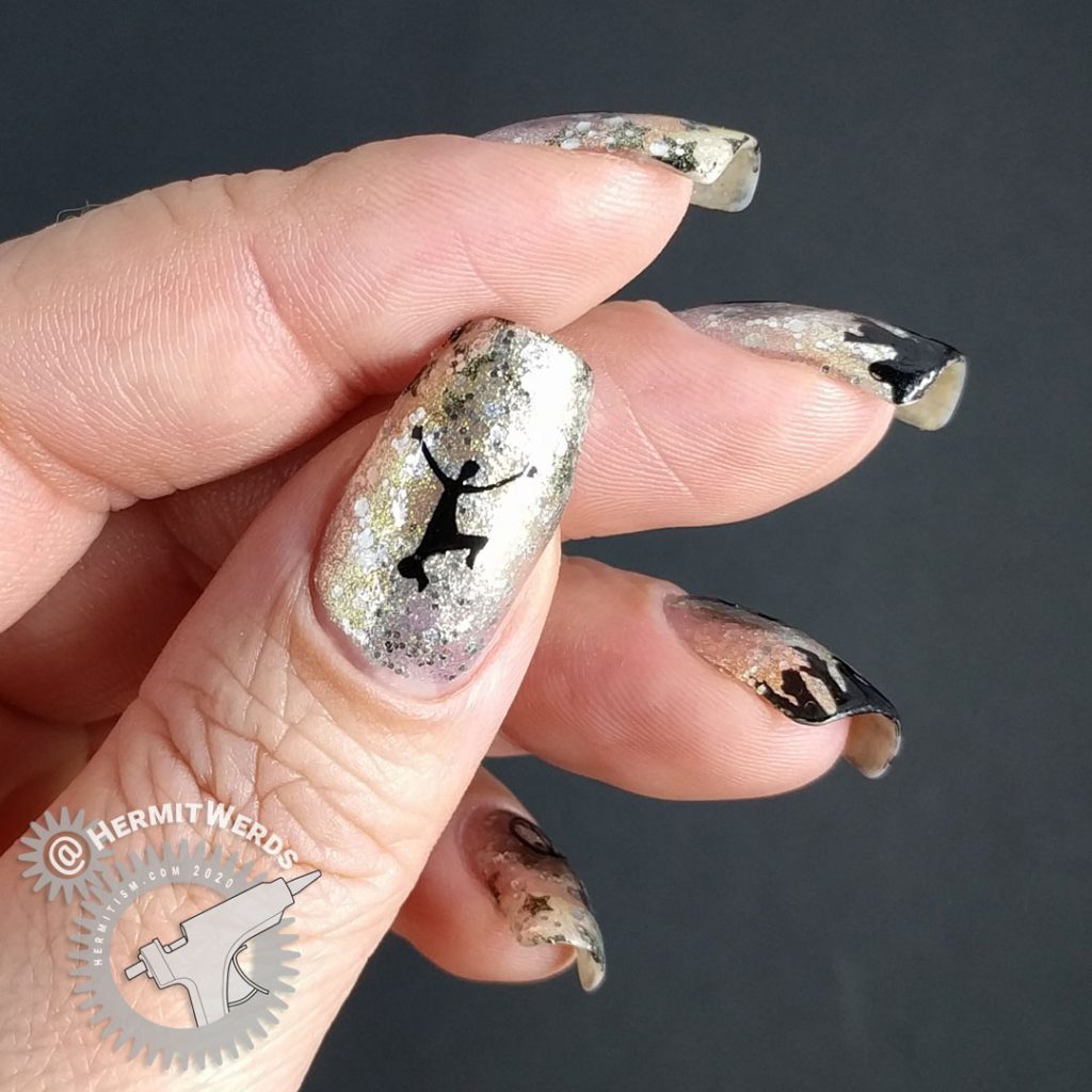 Glittery silver and gold nail art with people cheering and partying underneath a 2020 stamping image.