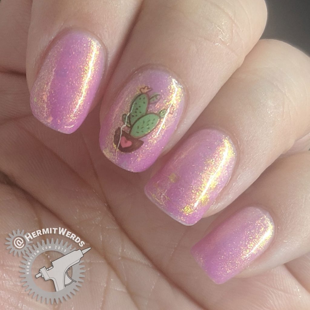 Pink and white thermal mani with adorable heart and cactus nail decals and gold shimmer.
