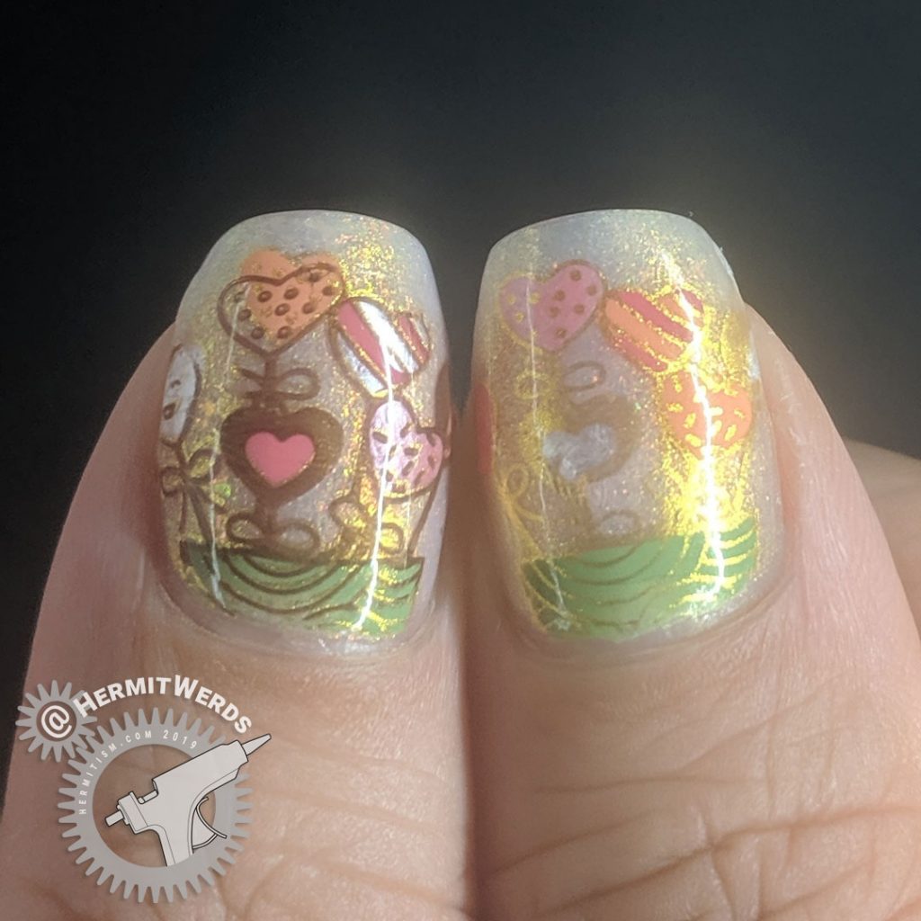 Pink and white thermal mani with adorable heart and cactus nail decals and gold shimmer.