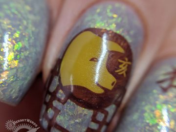 Year of the Pig nail art with pig stamping in all of the pig's lucky colors: brown, grey, and yellow.