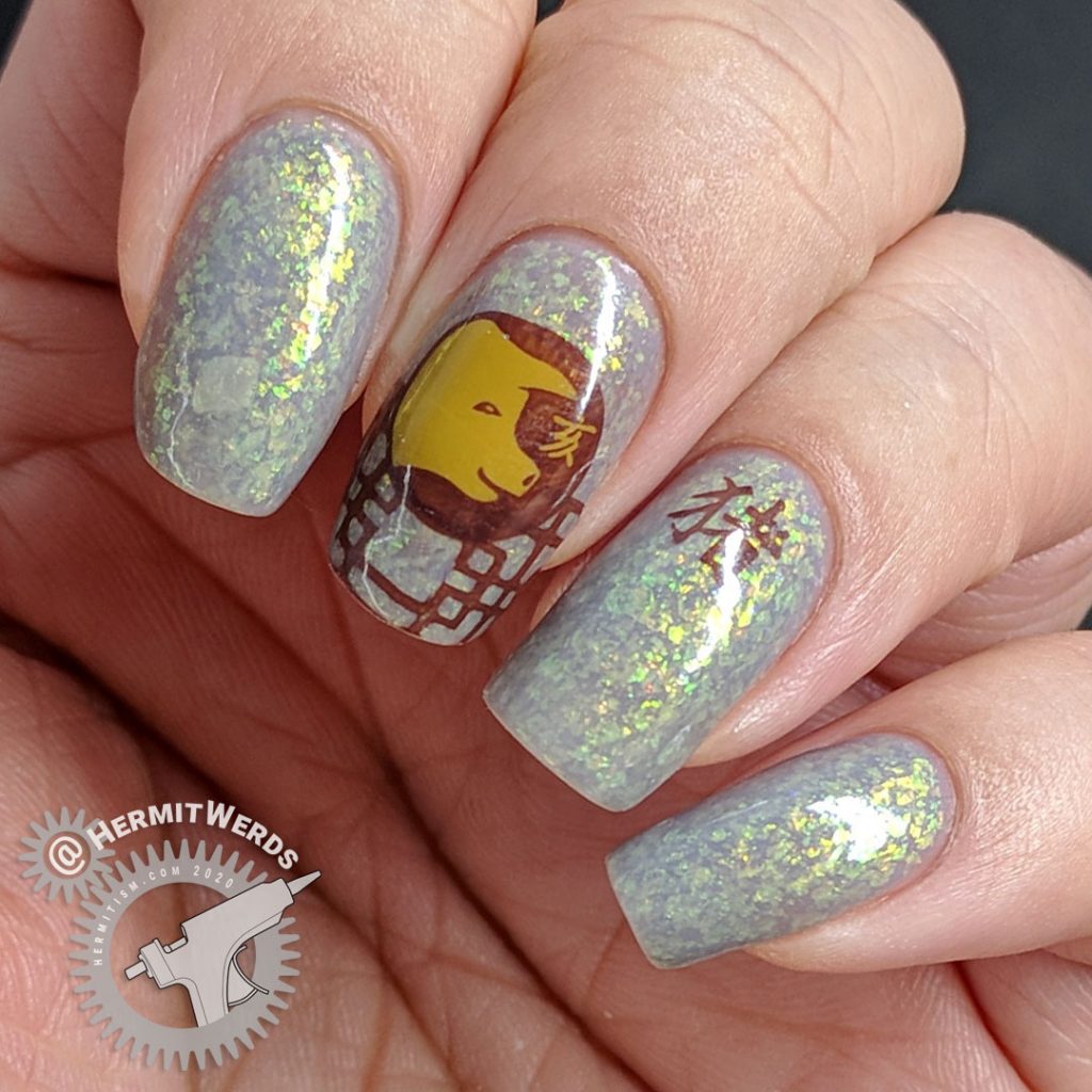 Year of the Pig nail art with pig stamping in all of the pig's lucky colors: brown, grey, and yellow.