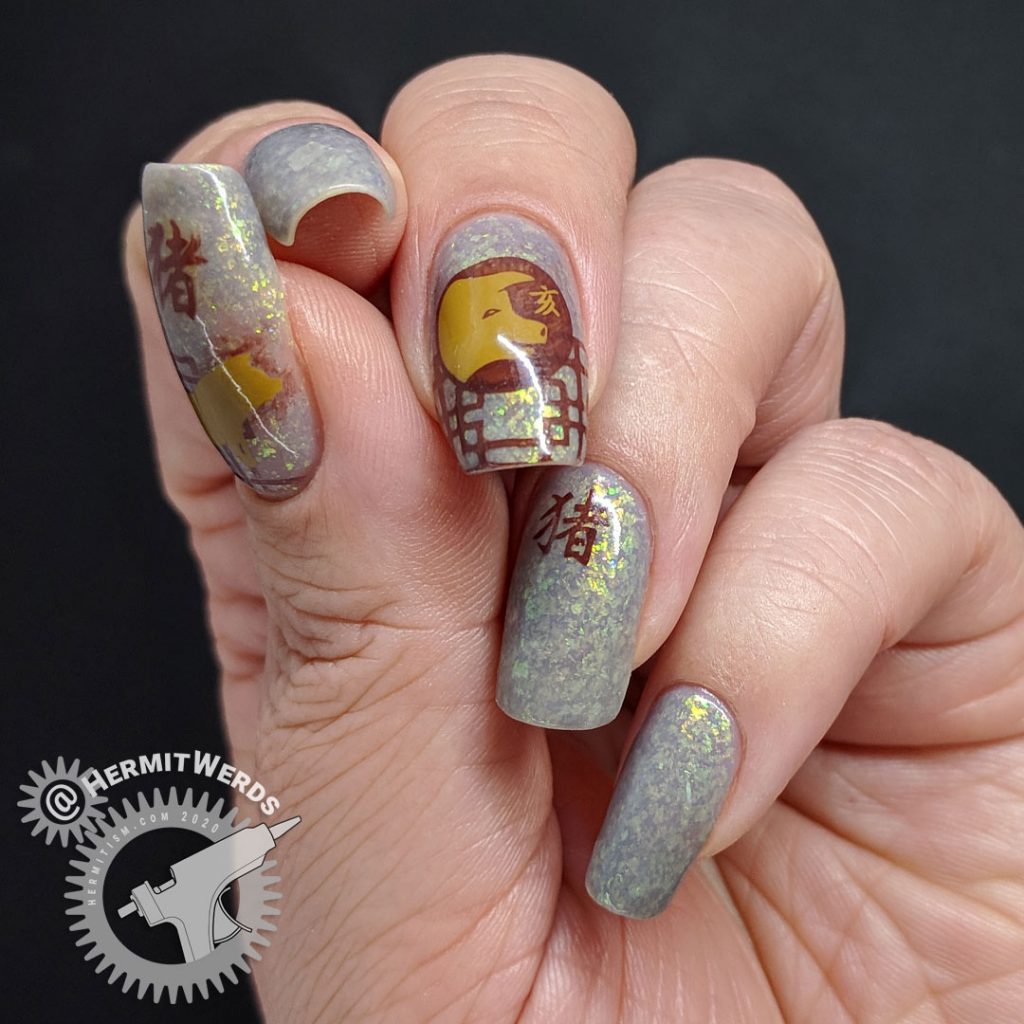 Year of the Pig nail art with pig stamping in all of the pig's lucky colors: brown, grey, and yellow.