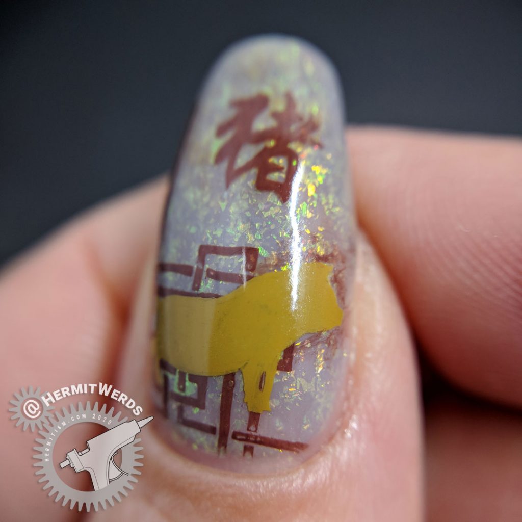 Year of the Pig nail art with pig stamping in all of the pig's lucky colors: brown, grey, and yellow.