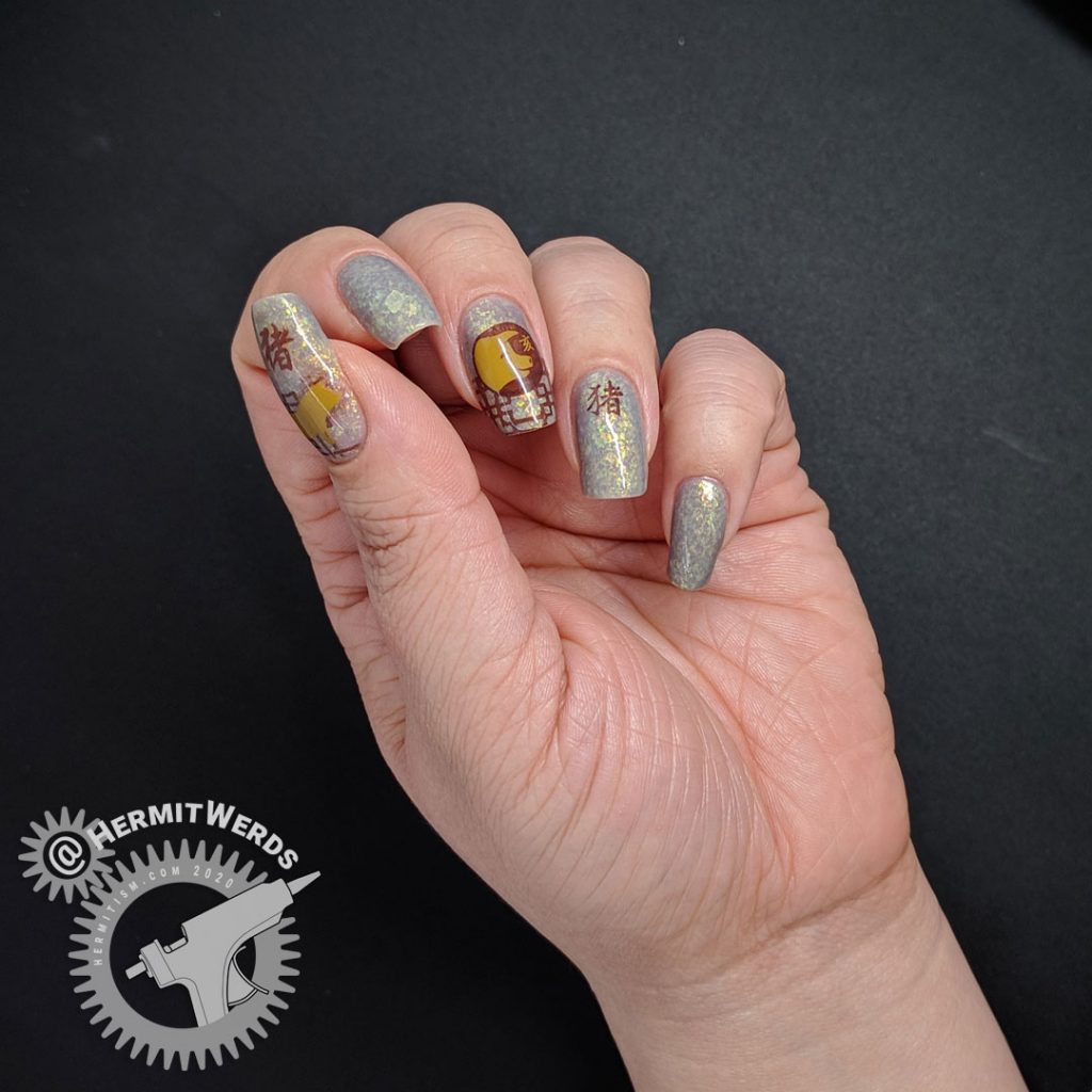 Year of the Pig nail art with pig stamping in all of the pig's lucky colors: brown, grey, and yellow.