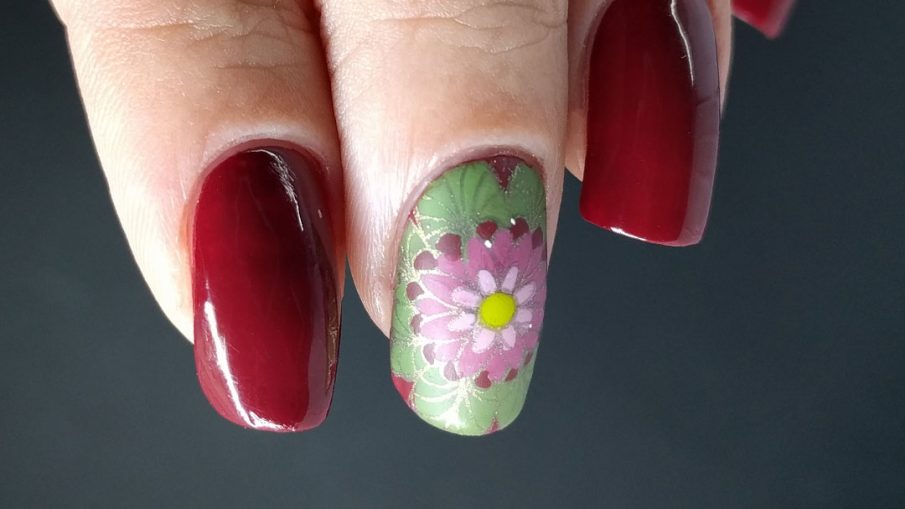 A deep red (merlot) nail art with a few brightly colored mandala decals.